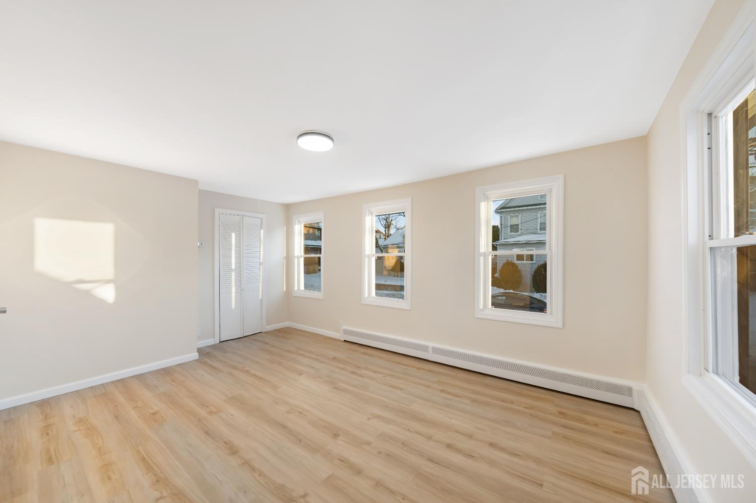 25 Dane Street Sayreville, NJ 08872 - Photo 15 of 31 an empty room with wooden floor and windows