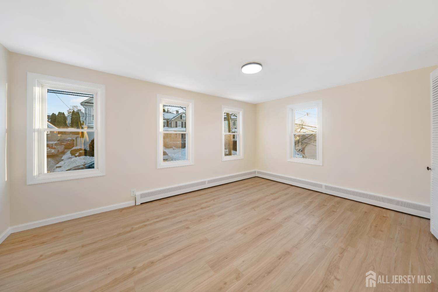 25 Dane Street Sayreville, NJ 08872 - Photo 16 of 31 a view of an empty room with wooden floor and a window