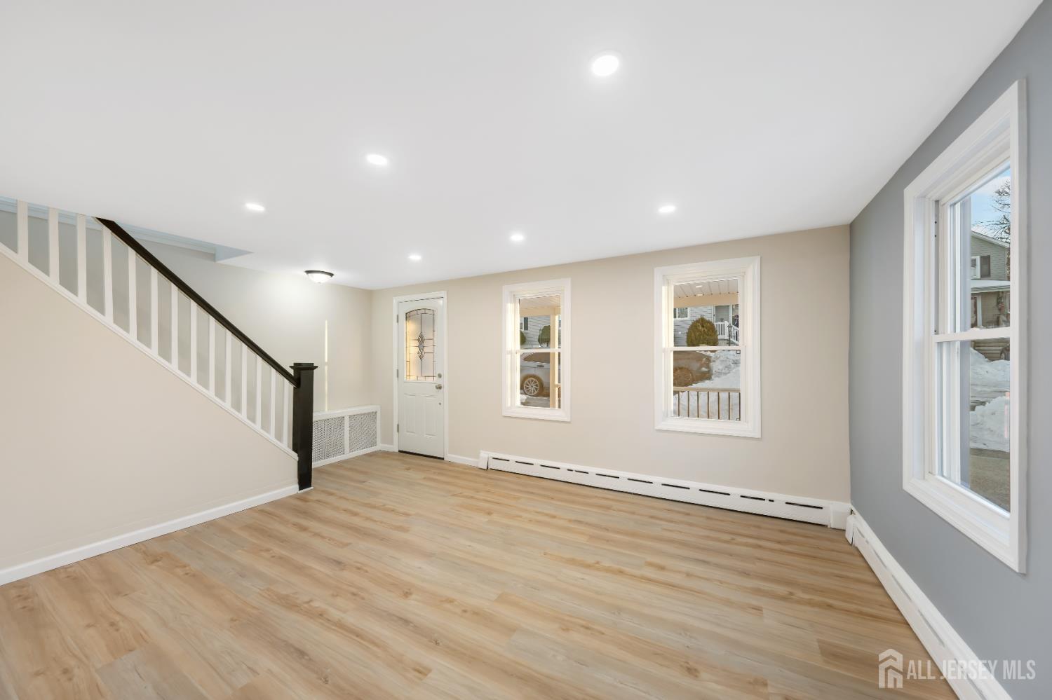 25 Dane Street Sayreville, NJ 08872 - Photo 6 of 31 a view of an empty room with wooden floor and a window
