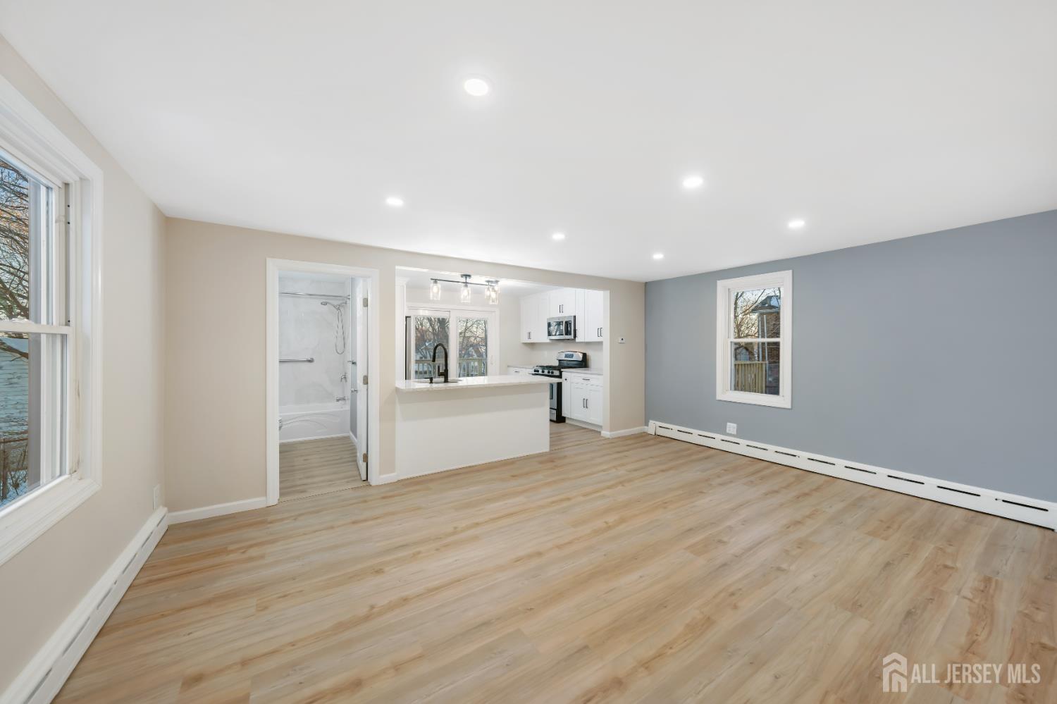 25 Dane Street Sayreville, NJ 08872 - Photo 7 of 31 a view of an empty room with wooden floor and a window