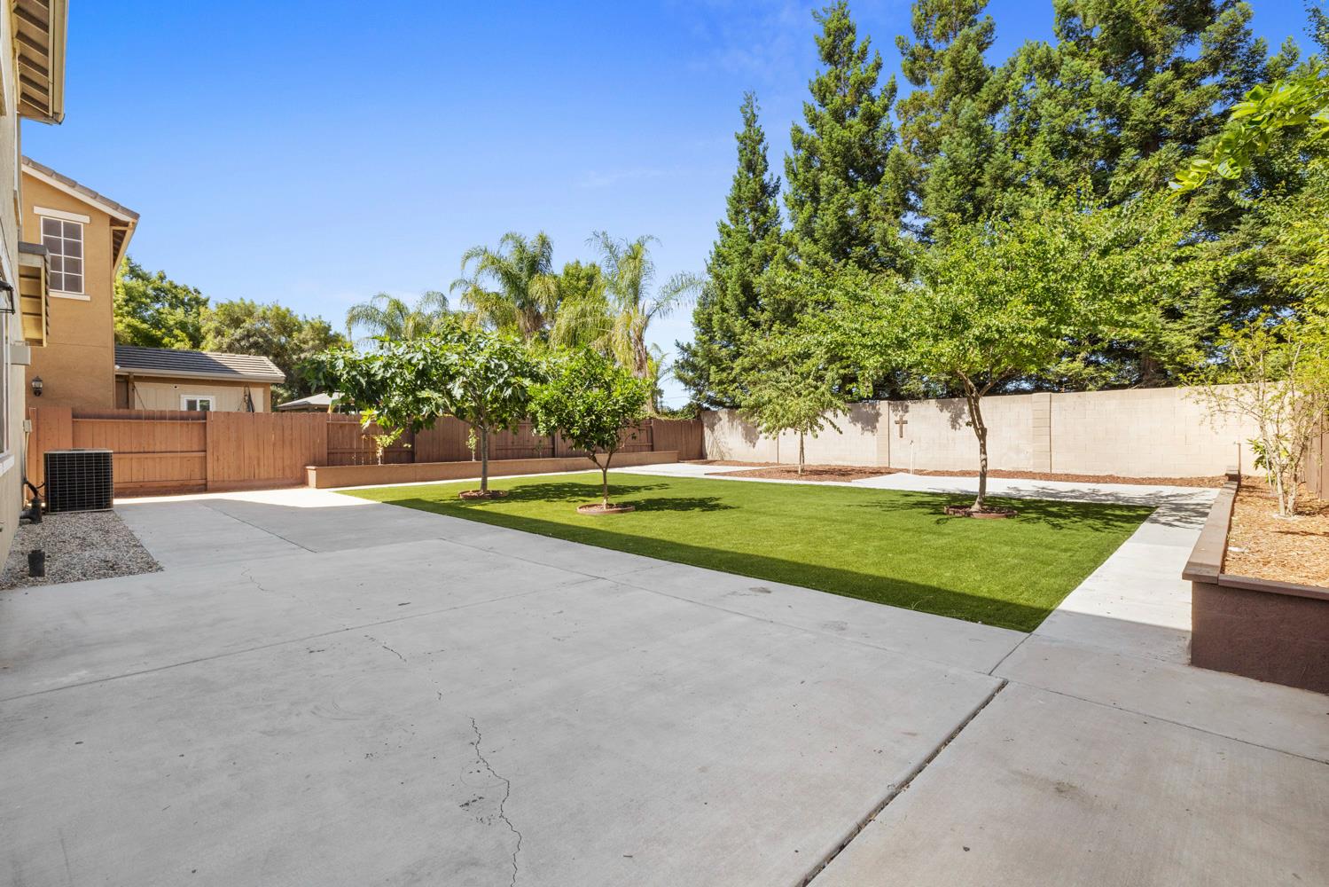 3105 Ripple Court Modesto, CA 95355 - Photo 44 of 46 a view of a house with a big yard and large trees