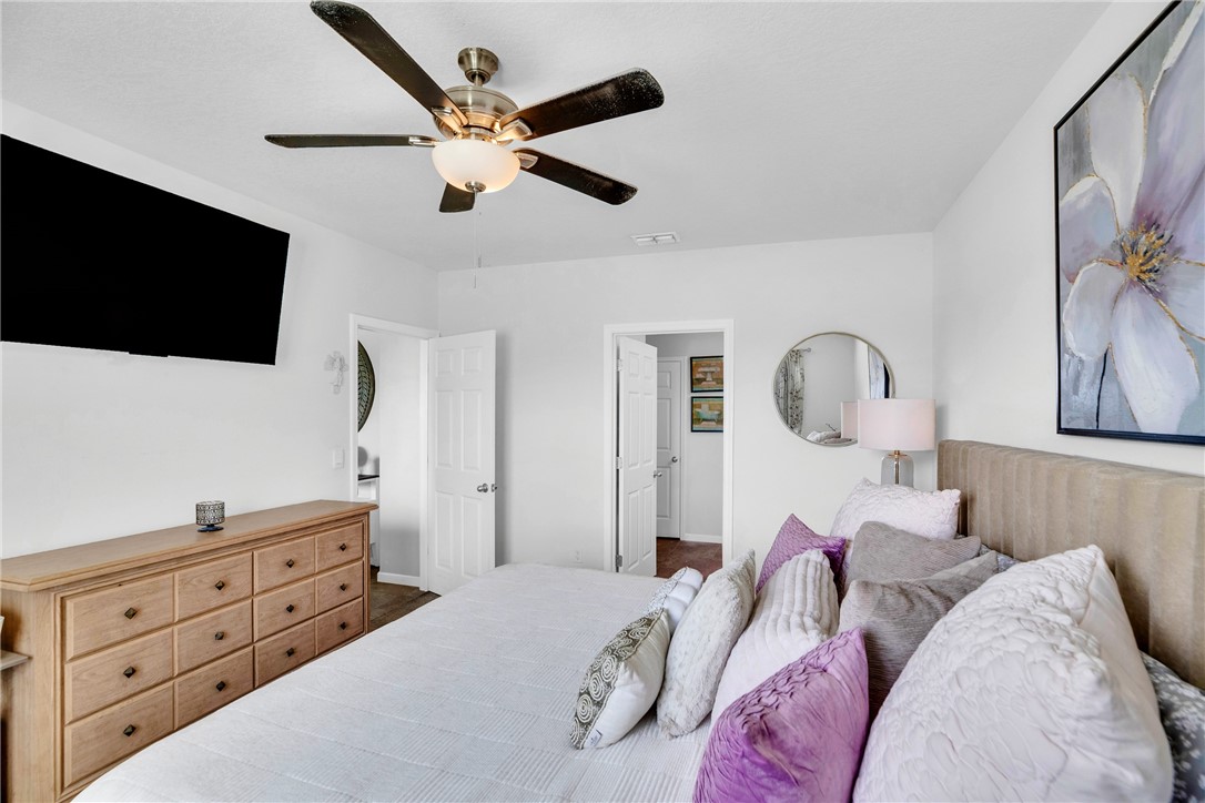 3453 Trinity Circle Fort Pierce, FL 34945 - Photo 14 of 36 a bedroom with a bed and a flat screen tv