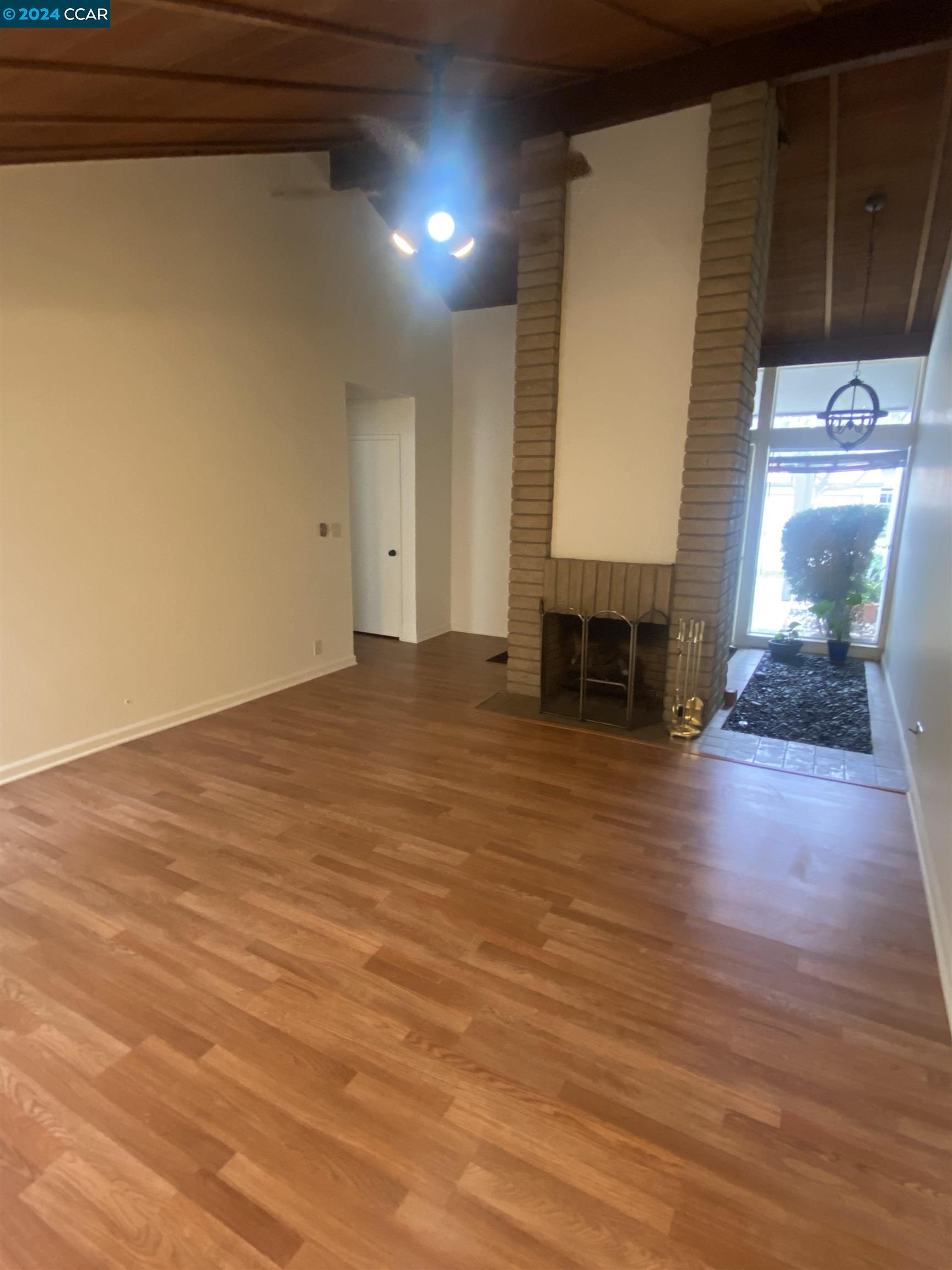 506 Tampico Walnut Creek, CA 94598 - Photo 16 of 32 a view of empty room with wooden floor and fireplace