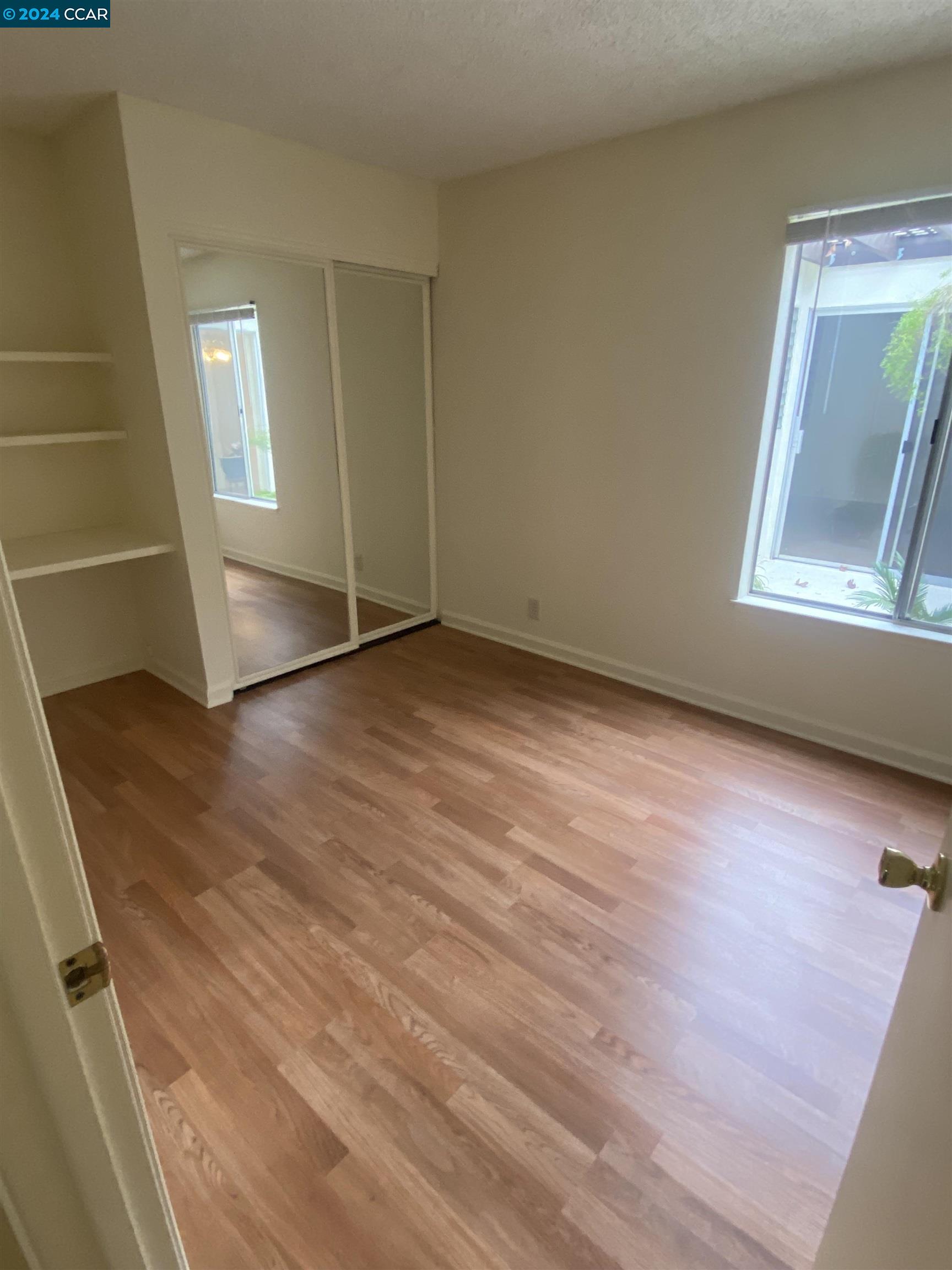 506 Tampico Walnut Creek, CA 94598 - Photo 18 of 32 a view of an empty room with wooden floor and a window