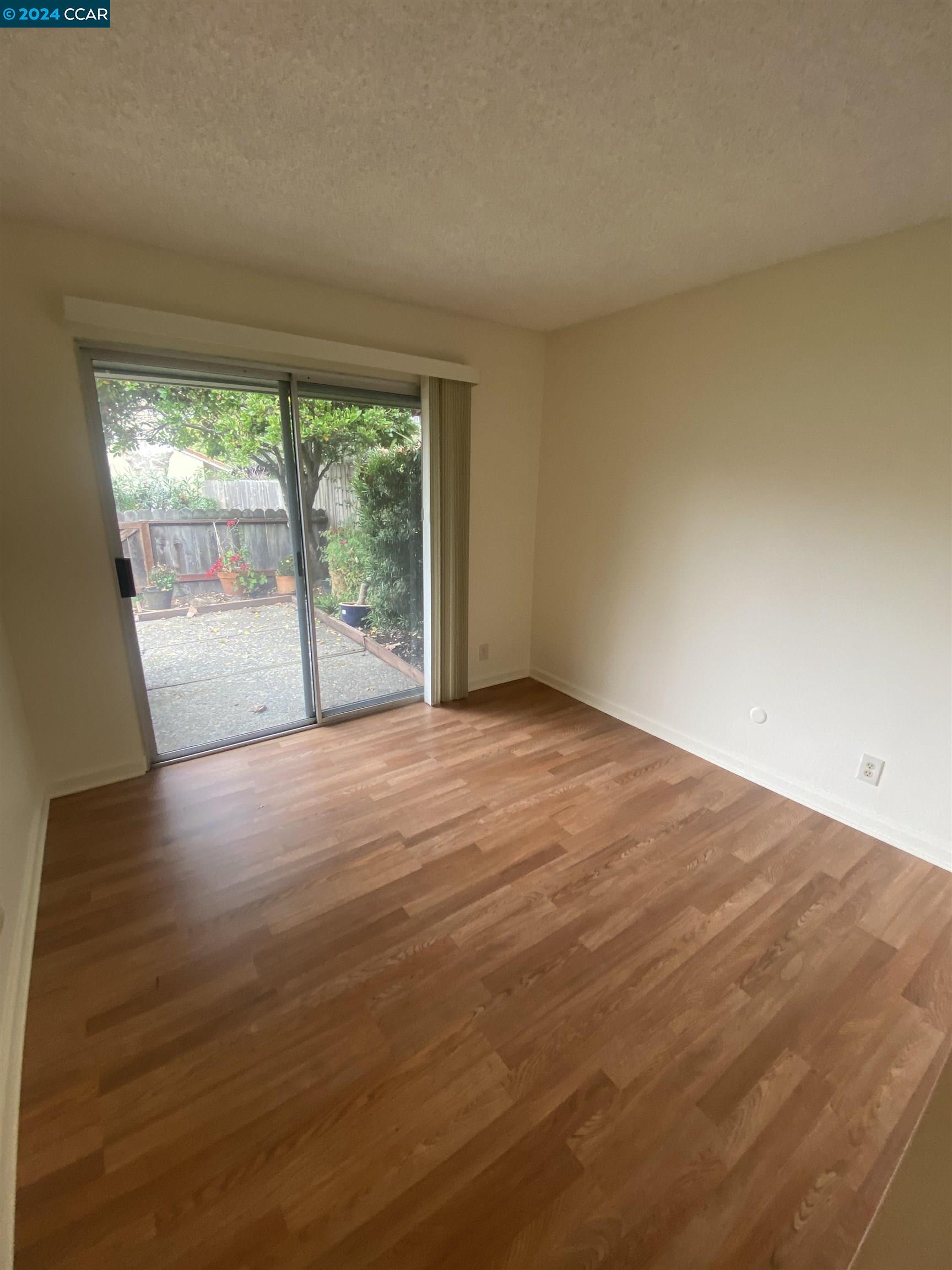 506 Tampico Walnut Creek, CA 94598 - Photo 25 of 32 an empty room with wooden floor and windows