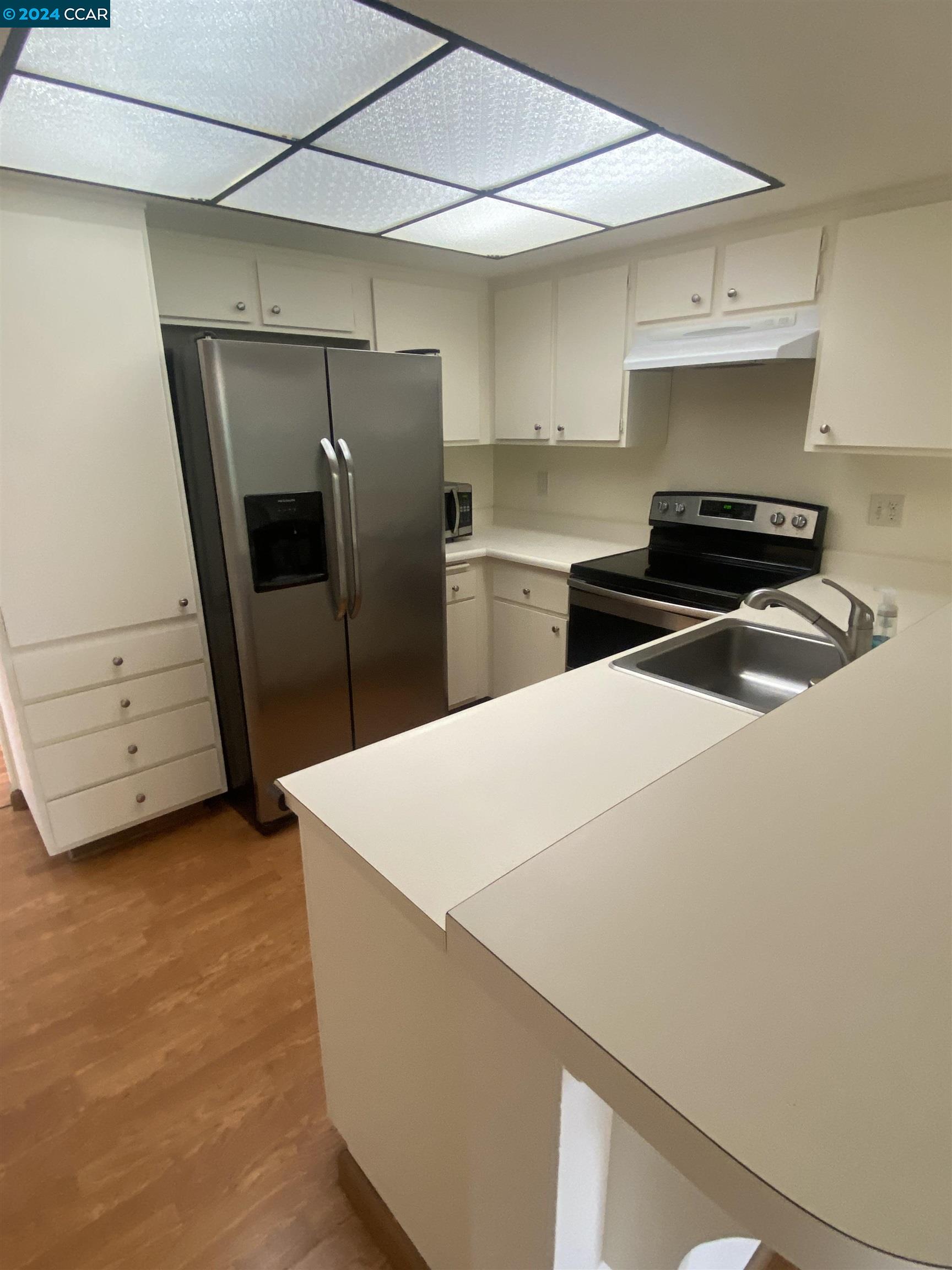 506 Tampico Walnut Creek, CA 94598 - Photo 8 of 32 a kitchen with stainless steel appliances a refrigerator and a stove