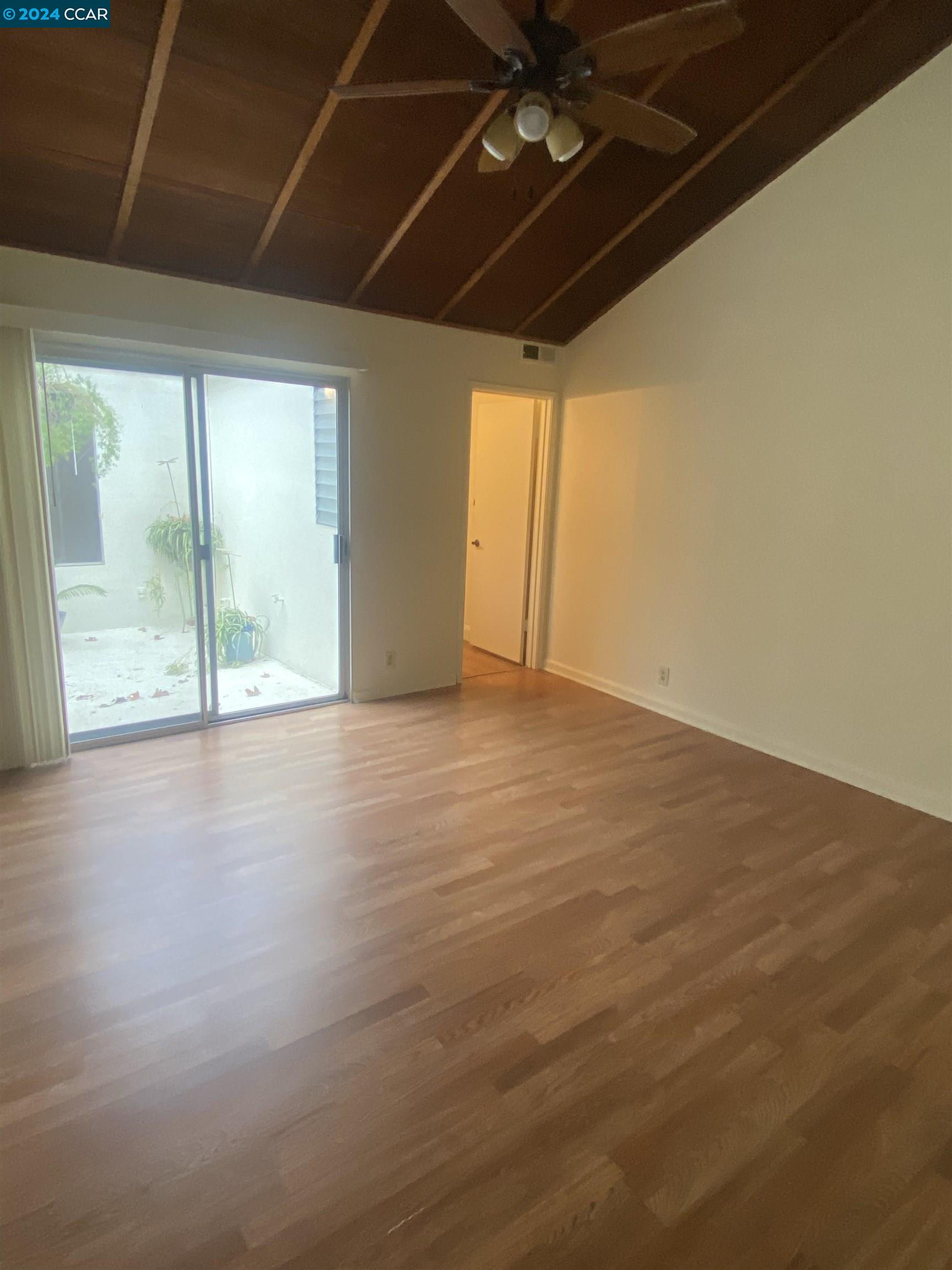 506 Tampico Walnut Creek, CA 94598 - Photo 10 of 32 an empty room with wooden floor and windows