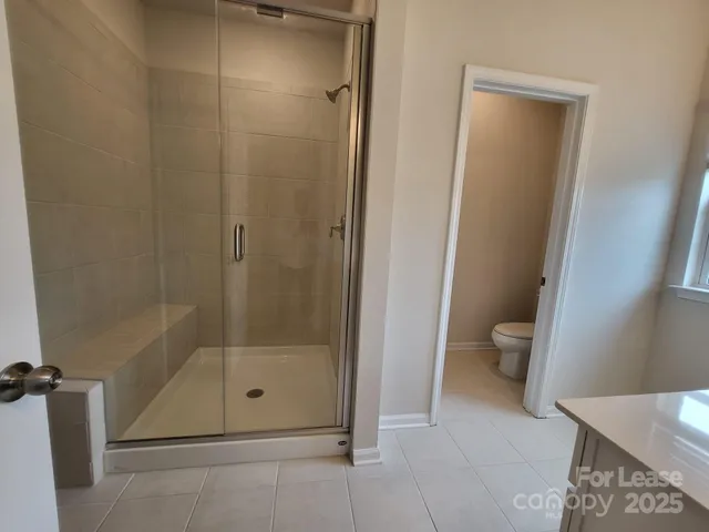 a bathroom with a shower and toilet