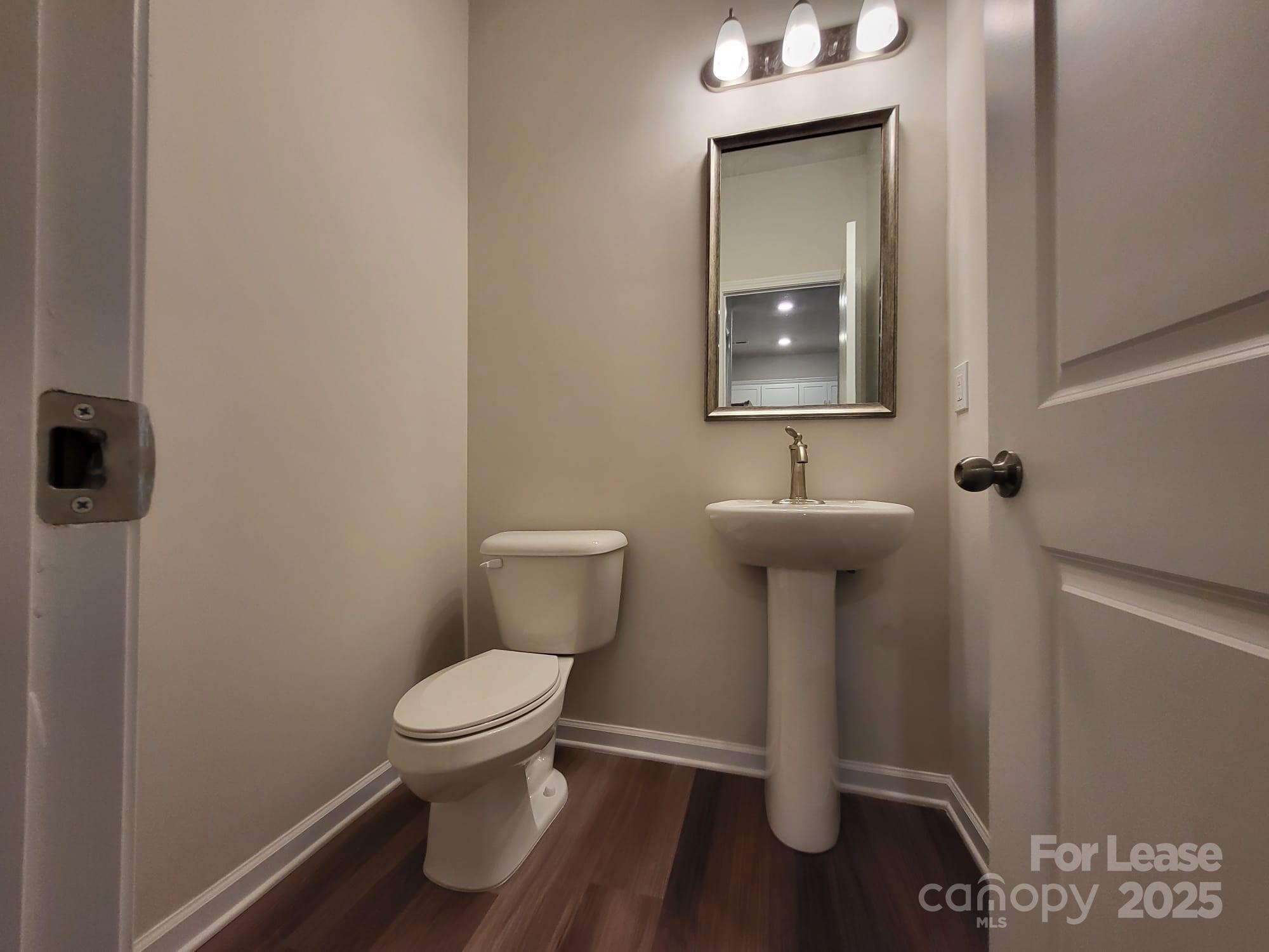 3511 Glenn Hope Way Matthews, NC 28104 - Photo 14 of 17 a bathroom with a toilet sink and mirror