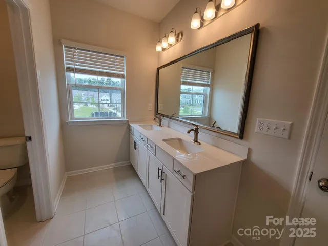 a bathroom with a double vanity sink a and mirror