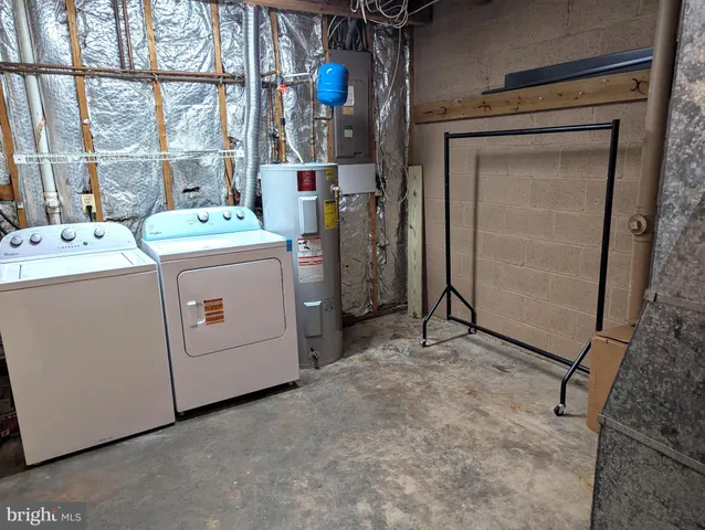 a view of storage and utility room with washer and dryer