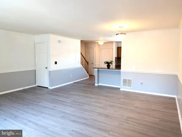 a kitchen with stainless steel appliances kitchen island granite countertop a stove a sink dishwasher and a refrigerator