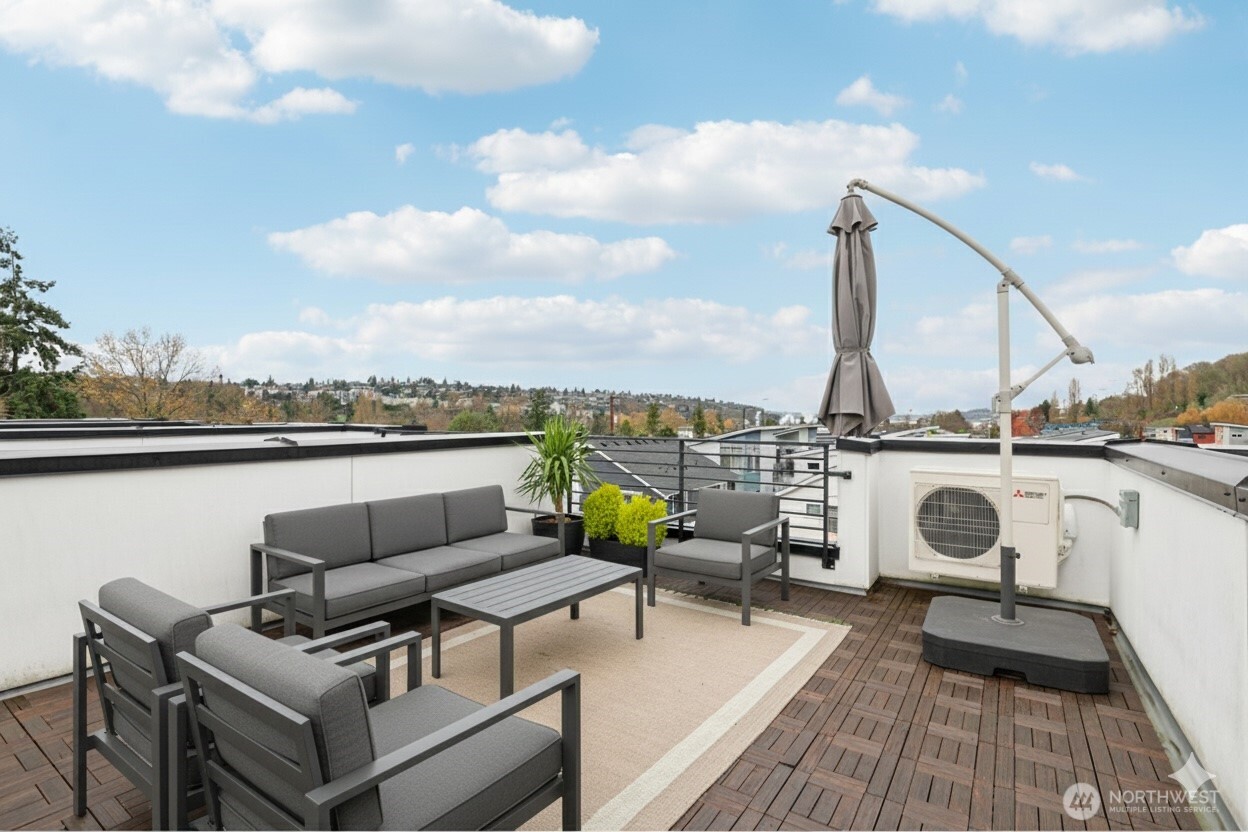 2403 Southwest Edmunds Street Seattle, WA 98106 - Photo 21 of 25 a roof deck with couches and wooden floor