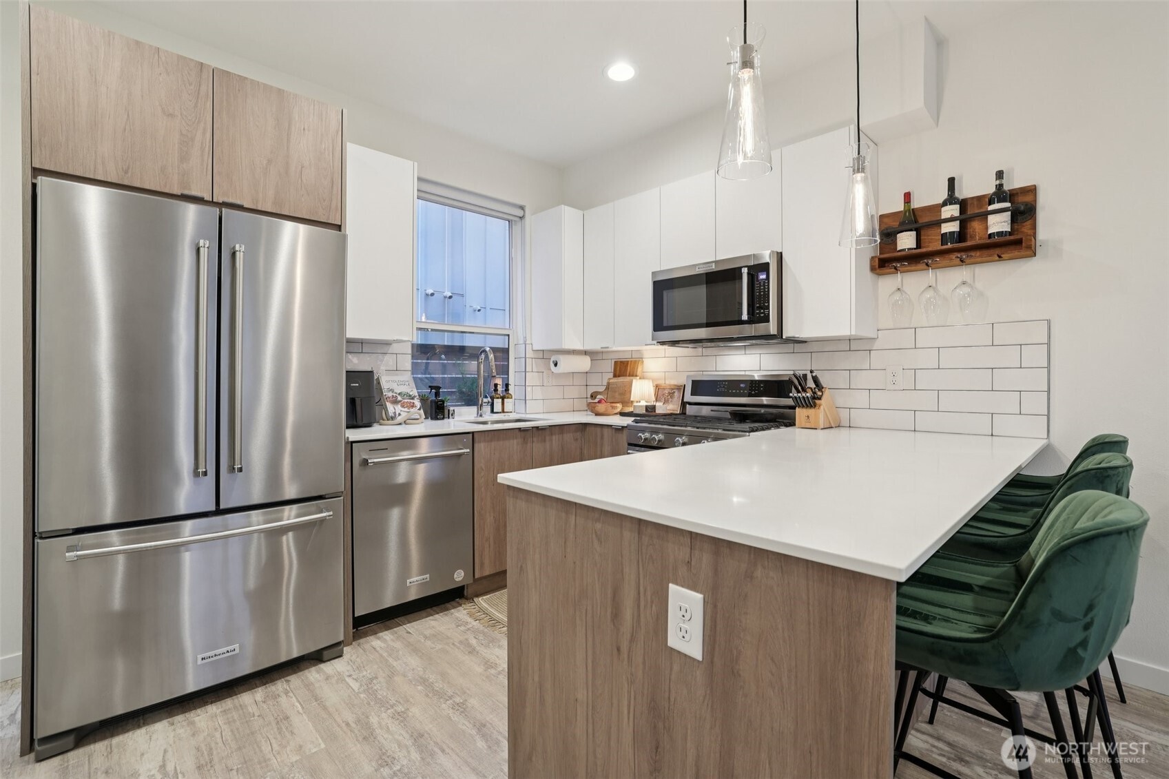2403 Southwest Edmunds Street Seattle, WA 98106 - Photo 8 of 25 a kitchen with stainless steel appliances a refrigerator stove microwave and sink