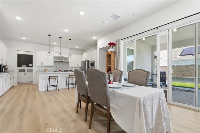 a living room with kitchen island furniture and a flat screen tv