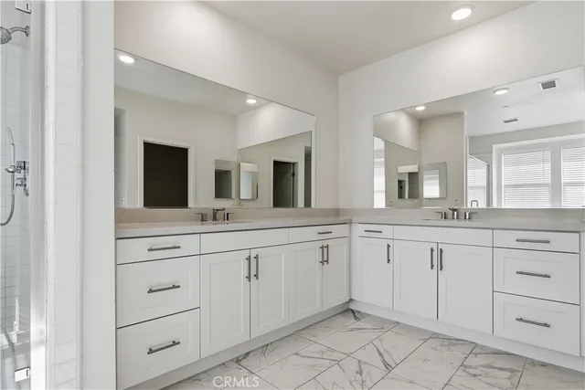 a spacious bathroom with a granite countertop sink and mirror