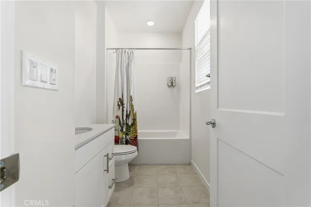 a bathroom with a shower a toilet and a shower