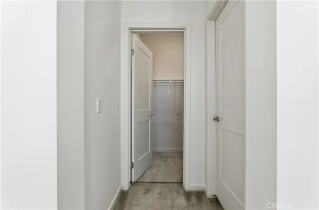 a view of a bathroom from a hallway with toilet