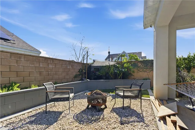a bench sitting in a backyard with potted plants