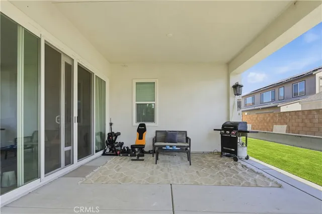 a living room with furniture and a floor to ceiling window
