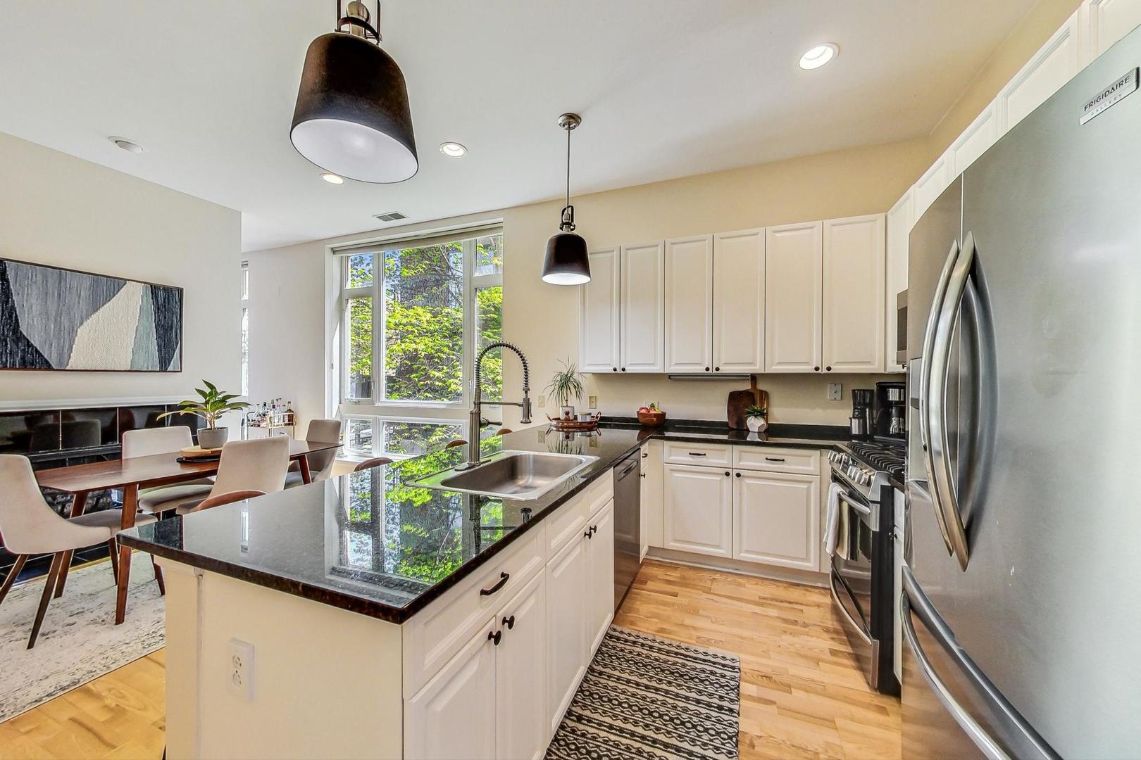 4150 North Sheridan Road, Unit 2S Chicago, IL 60613 - Photo 12 of 29 a kitchen with stainless steel appliances granite countertop a sink a stove and a refrigerator
