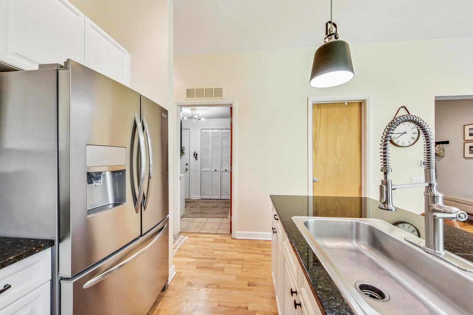 4150 North Sheridan Road, Unit 2S Chicago, IL 60613 - Photo 13 of 29 a kitchen with stainless steel appliances granite countertop a refrigerator and a sink
