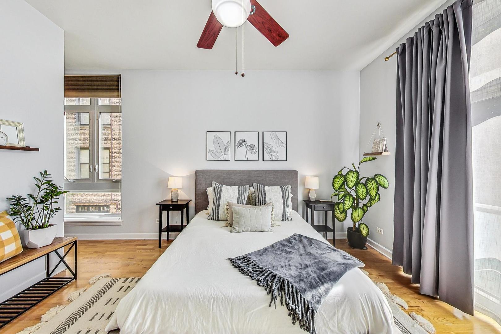 4150 North Sheridan Road, Unit 2S Chicago, IL 60613 - Photo 16 of 29 a bedroom with a bed and a potted plant