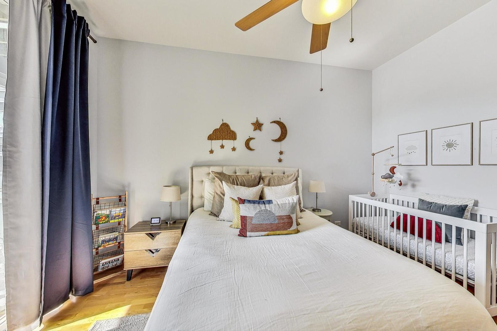 4150 North Sheridan Road, Unit 2S Chicago, IL 60613 - Photo 22 of 29 a bedroom with furniture and a chandelier