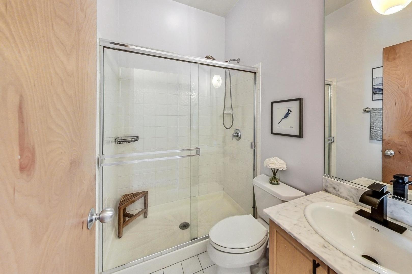4150 North Sheridan Road, Unit 2S Chicago, IL 60613 - Photo 23 of 29 a bathroom with a sink toilet and shower