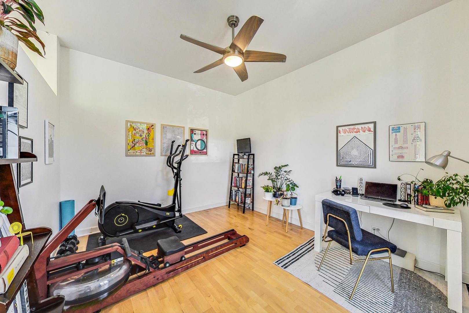 4150 North Sheridan Road, Unit 2S Chicago, IL 60613 - Photo 24 of 29 a room with gym equipment and a flat screen tv