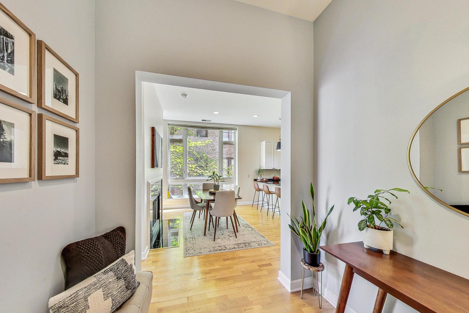 4150 North Sheridan Road, Unit 2S Chicago, IL 60613 - Photo 3 of 29 a view of a dining room with furniture and a potted plant