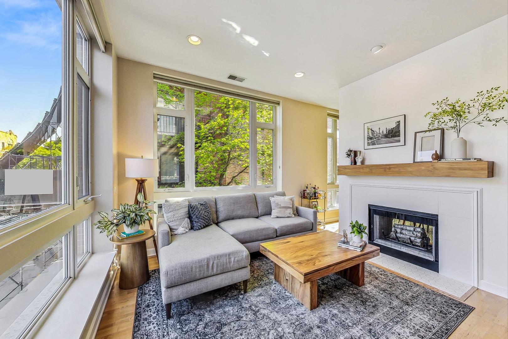 4150 North Sheridan Road, Unit 2S Chicago, IL 60613 - Photo 6 of 29 a living room with furniture a large window and a fireplace