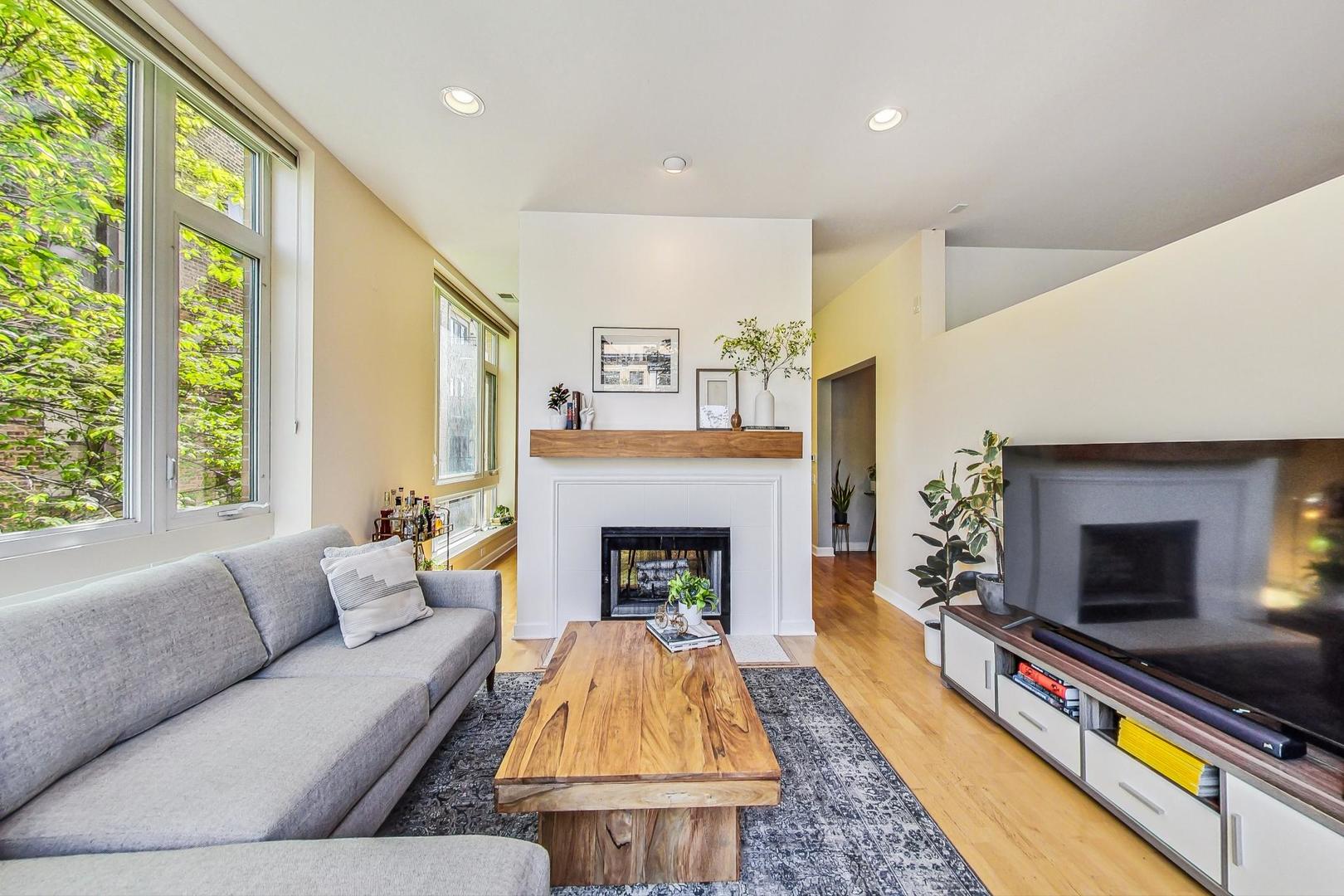4150 North Sheridan Road, Unit 2S Chicago, IL 60613 - Photo 7 of 29 a living room with furniture fireplace and flat screen tv