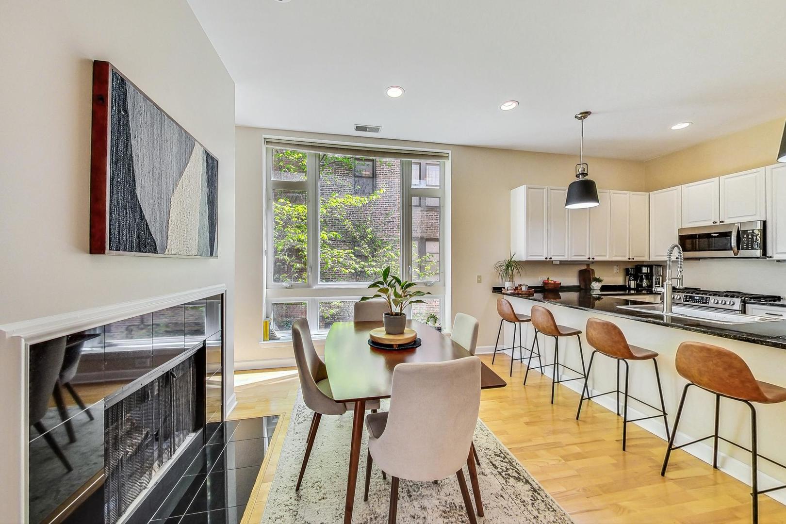 4150 North Sheridan Road, Unit 2S Chicago, IL 60613 - Photo 9 of 29 a view of a dining room with furniture window and wooden floor