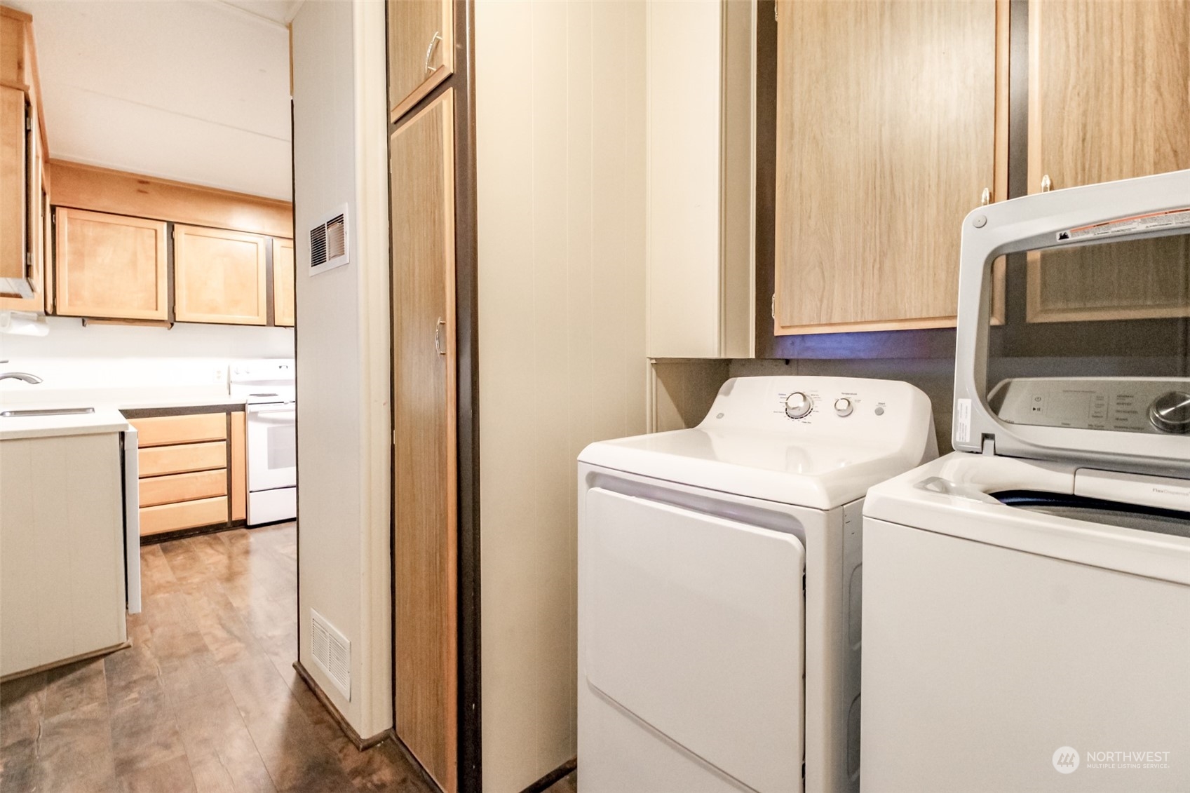 27508 220th Place Southeast Maple Valley, WA 98038 - Photo 19 of 25 a view of washer and dryer with bathroom in the background