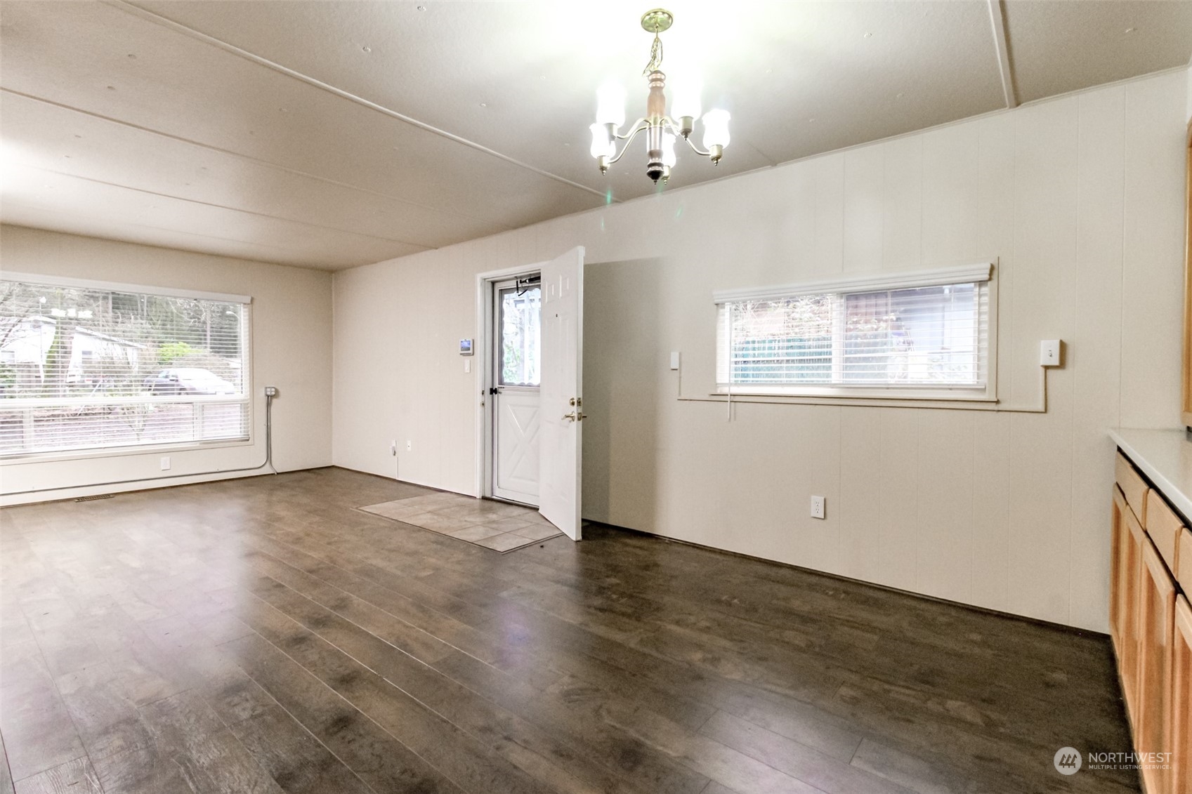 27508 220th Place Southeast Maple Valley, WA 98038 - Photo 6 of 25 a view of an empty room with wooden floor and a window