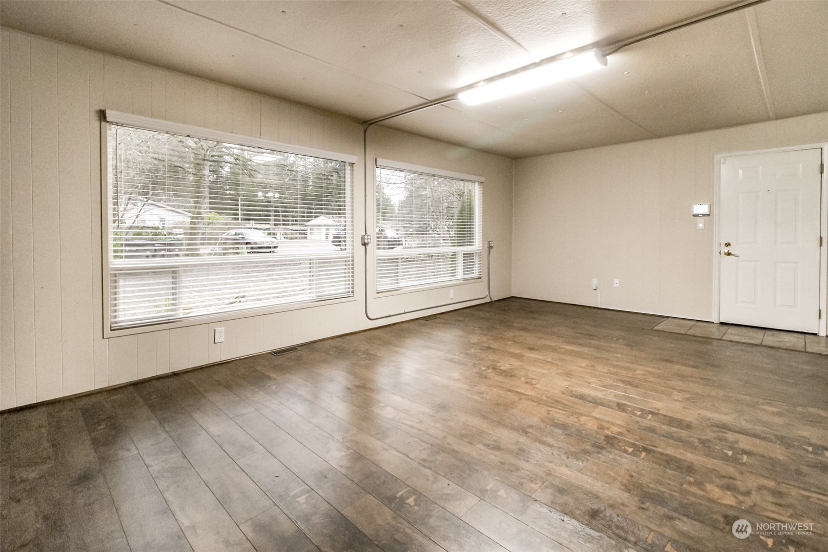 27508 220th Place Southeast Maple Valley, WA 98038 - Photo 7 of 25 an empty room with wooden floor and windows