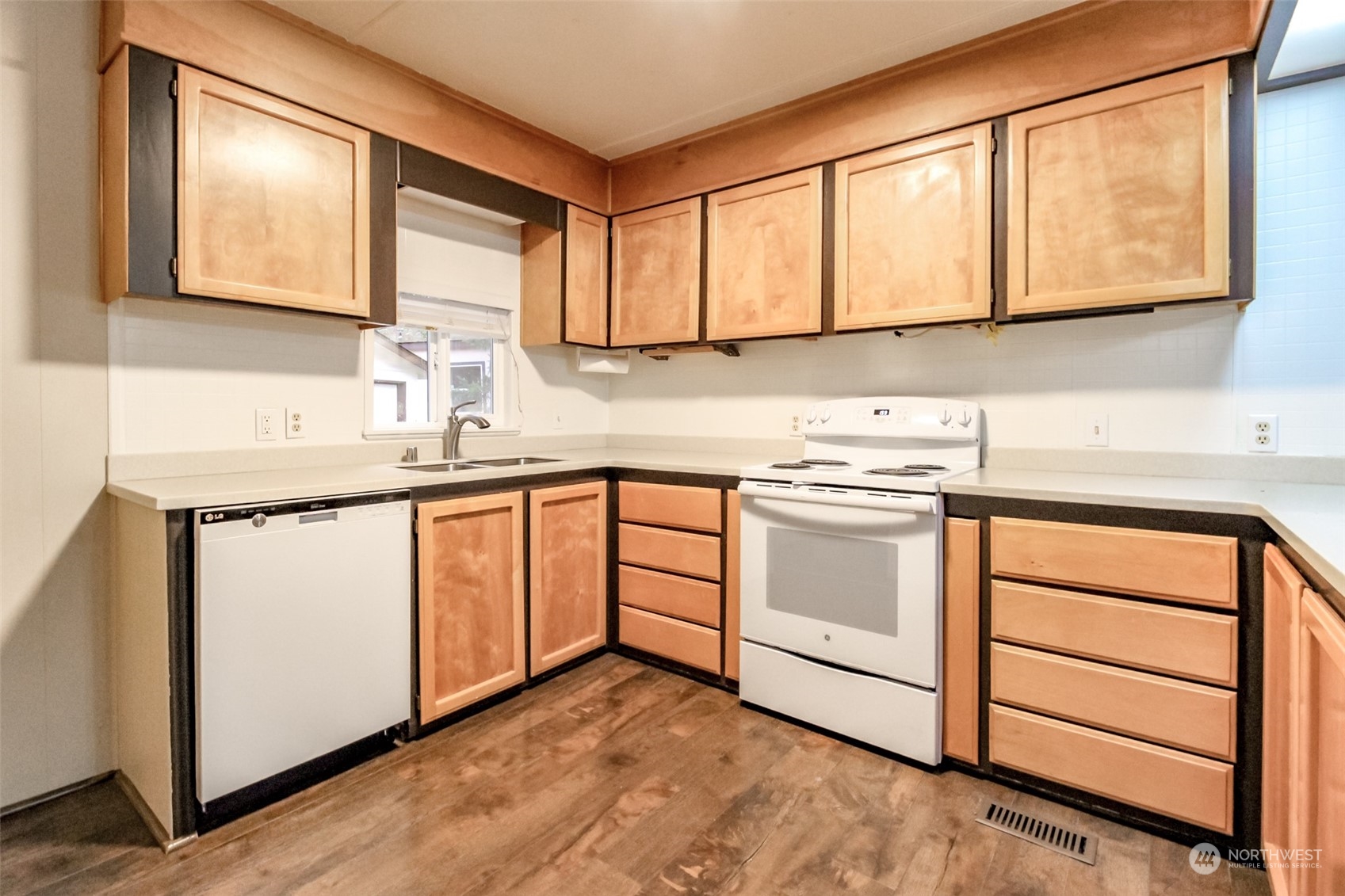 27508 220th Place Southeast Maple Valley, WA 98038 - Photo 9 of 25 a kitchen with stainless steel appliances granite countertop white cabinets sink and a granite counter top