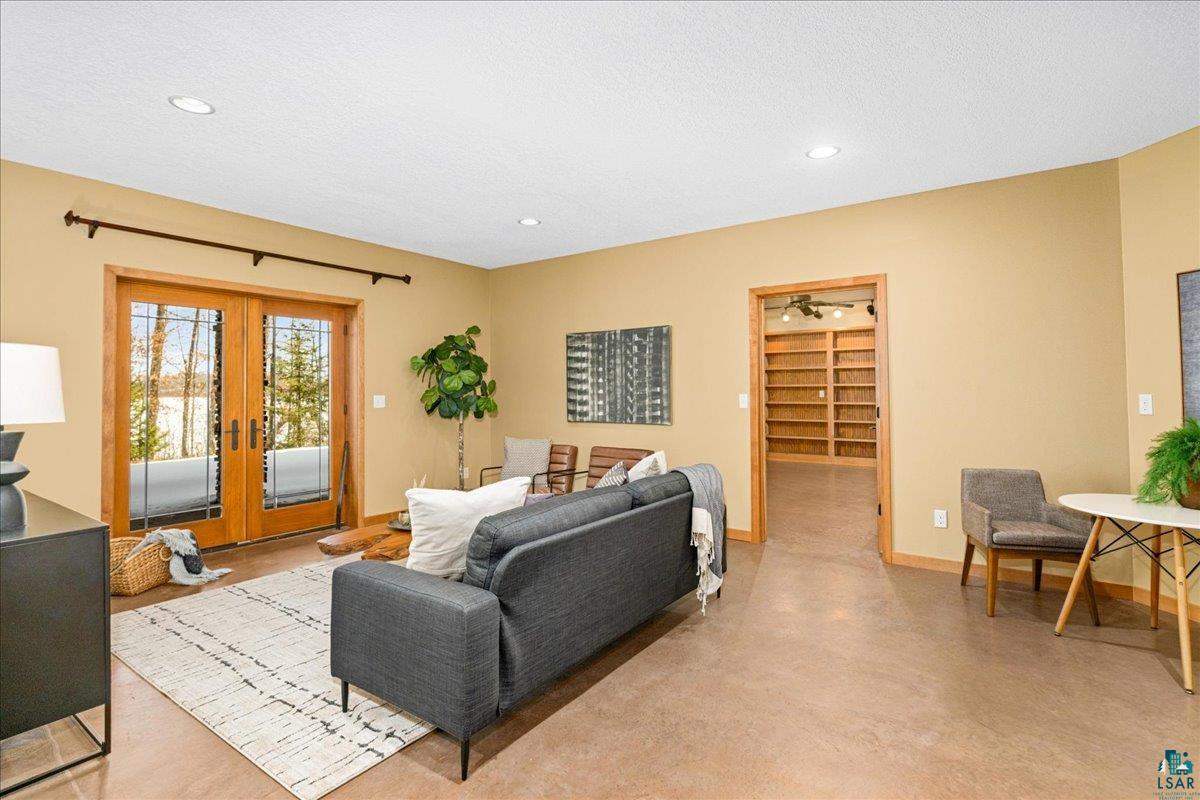 92598 Spells Road Sturgeon Lake, MN 55783 - Photo 39 of 60 Living room featuring french doors, concrete floors, and recessed lighting