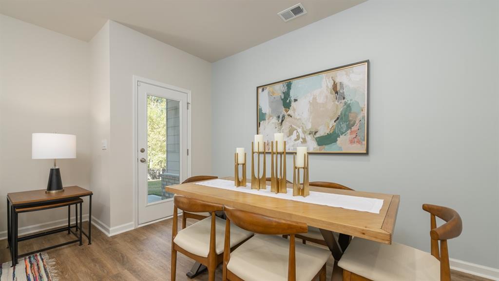 2082 Moss Hill Road Stone Mountain, GA 30083 - Photo 14 of 38 a view of a dining room with furniture and wooden floor