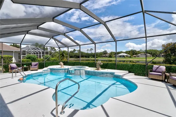 a view of a patio with a table and chairs under an umbrella