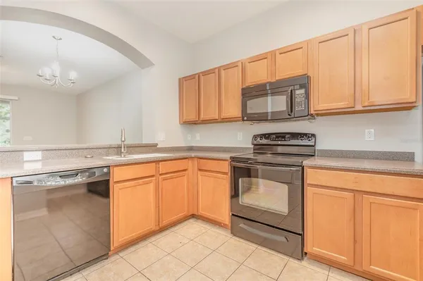 a kitchen with stainless steel appliances granite countertop a sink and a stove