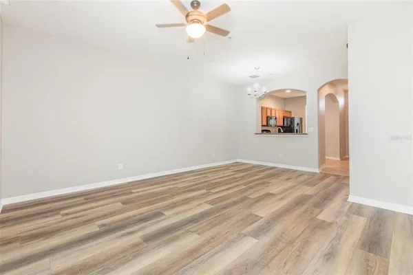 a view of a livingroom with a dishwasher cabinets and a chandelier fan