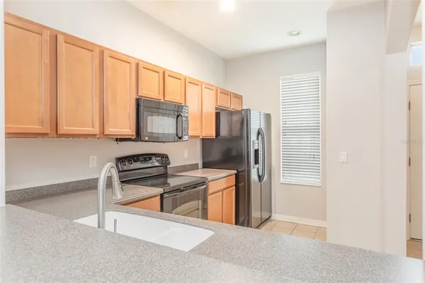 a kitchen with stainless steel appliances a refrigerator and a stove top oven