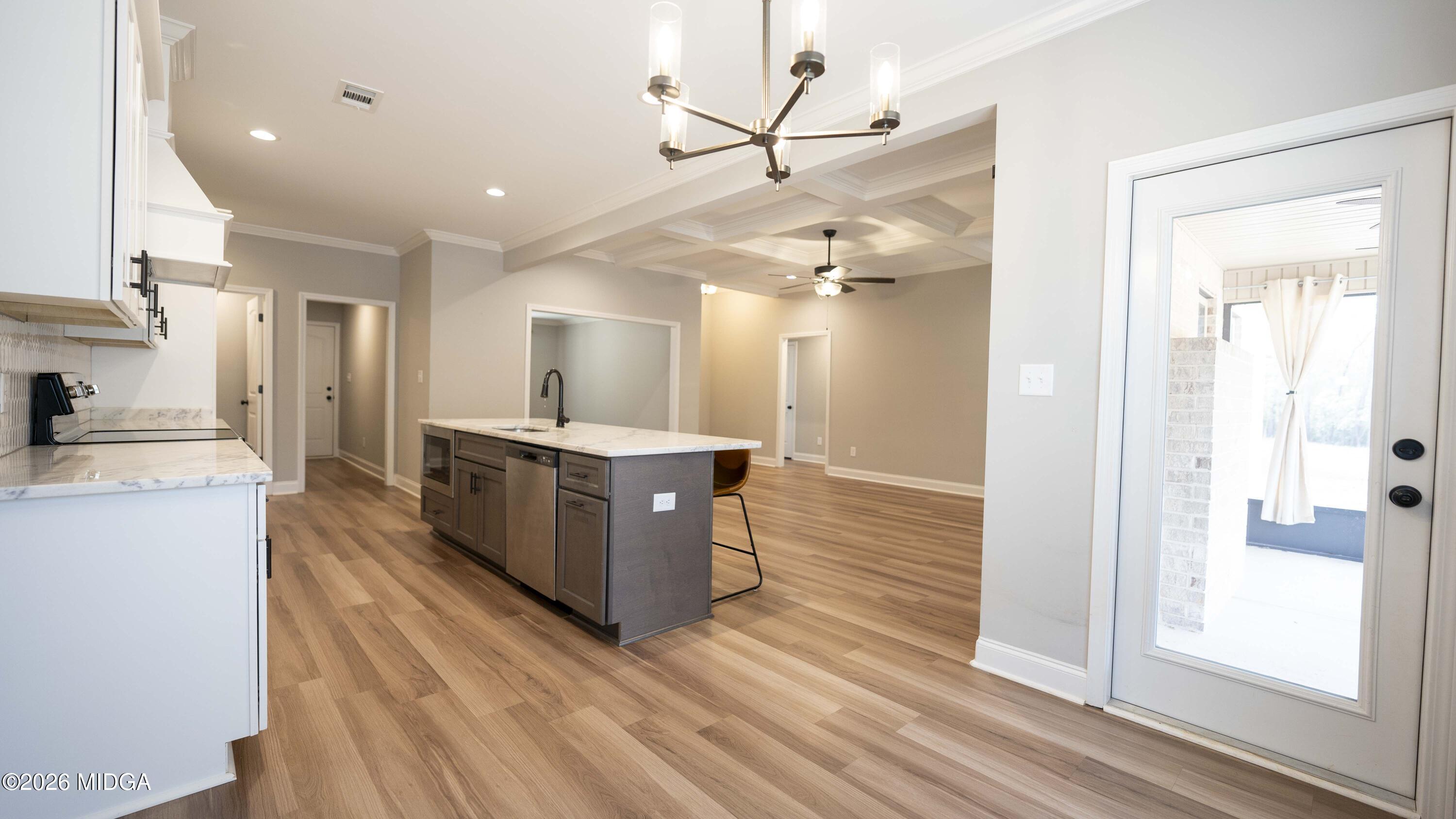 219 Otters Ridge Drive Kathleen, GA 31047 - Photo 15 of 44 a large kitchen with stainless steel appliances kitchen island a large counter top and a wooden floors