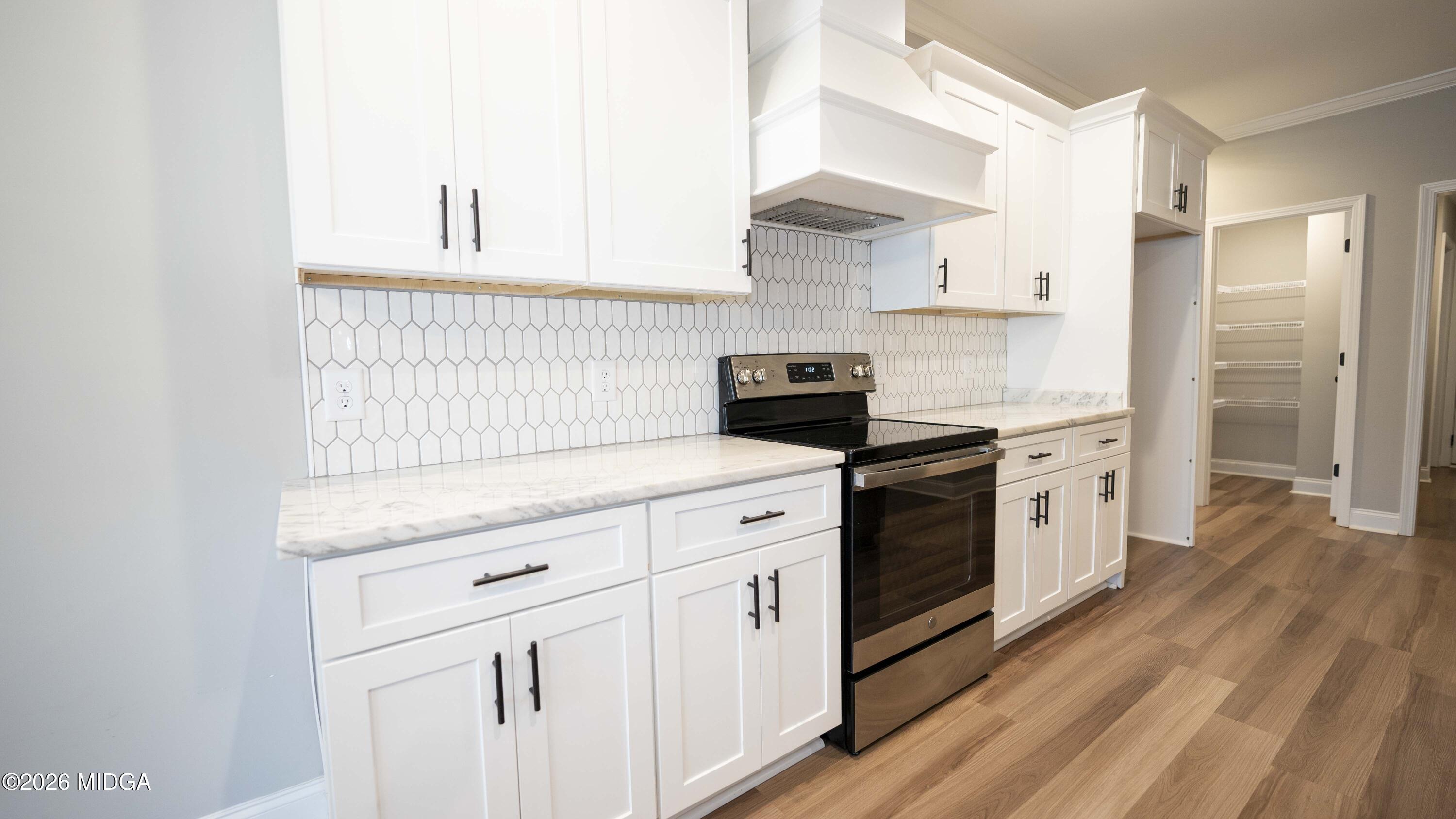 219 Otters Ridge Drive Kathleen, GA 31047 - Photo 16 of 44 a kitchen with white cabinets and white appliances