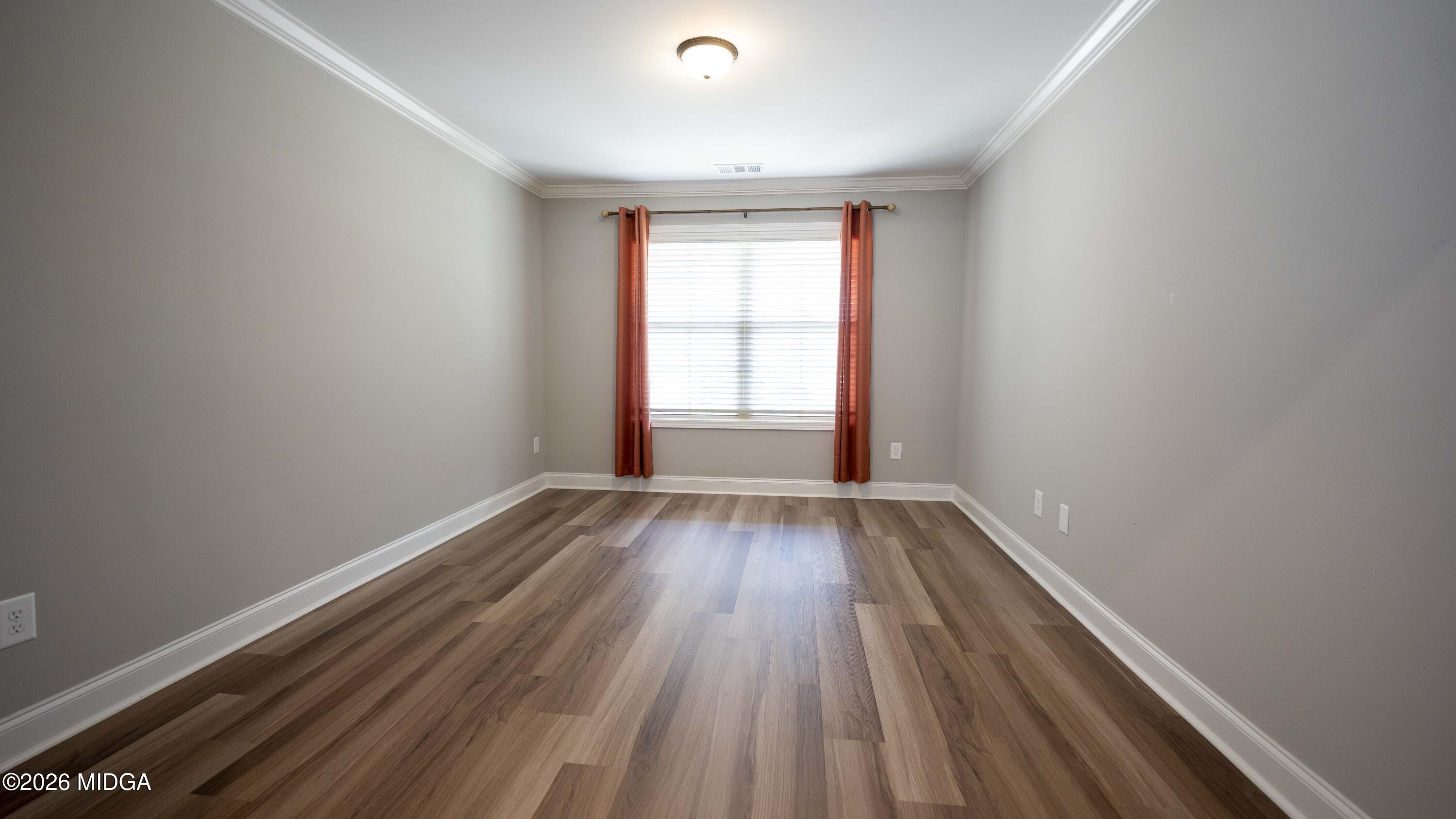 219 Otters Ridge Drive Kathleen, GA 31047 - Photo 19 of 44 a view of an empty room with wooden floor and a window