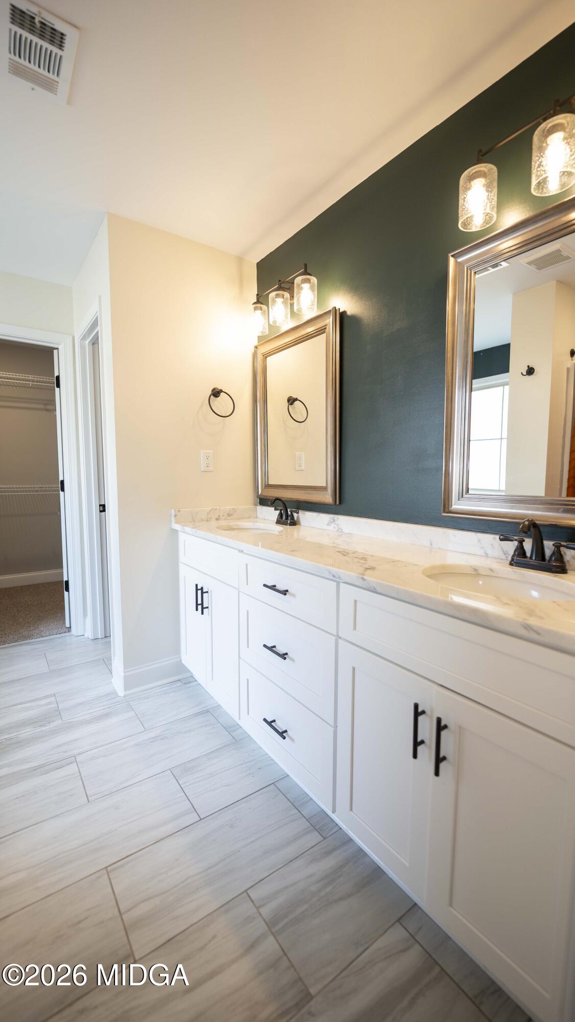219 Otters Ridge Drive Kathleen, GA 31047 - Photo 23 of 44 a spacious bathroom with a double vanity sink and mirror