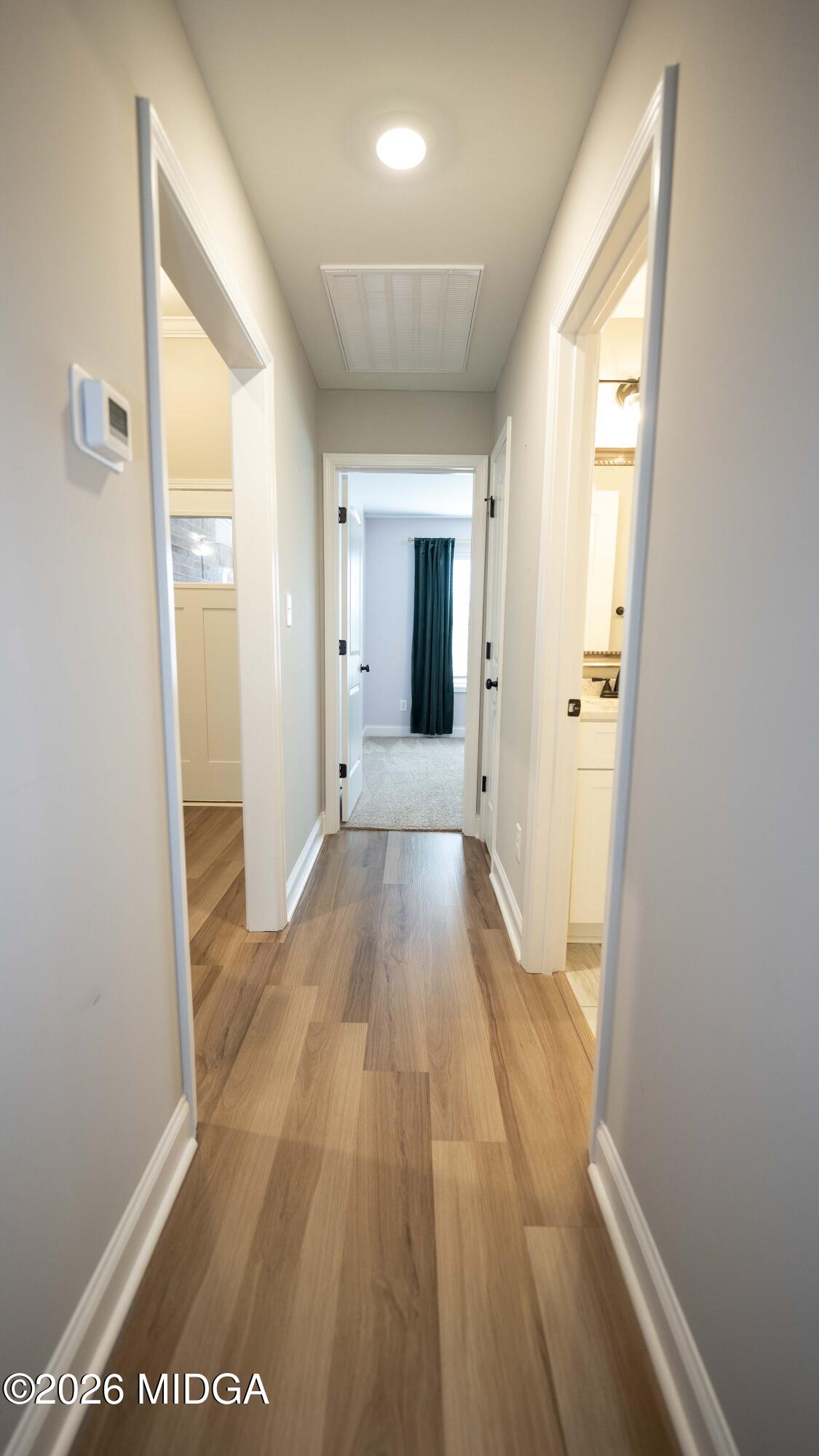 219 Otters Ridge Drive Kathleen, GA 31047 - Photo 30 of 44 a view of a hallway with wooden floor and a bathroom