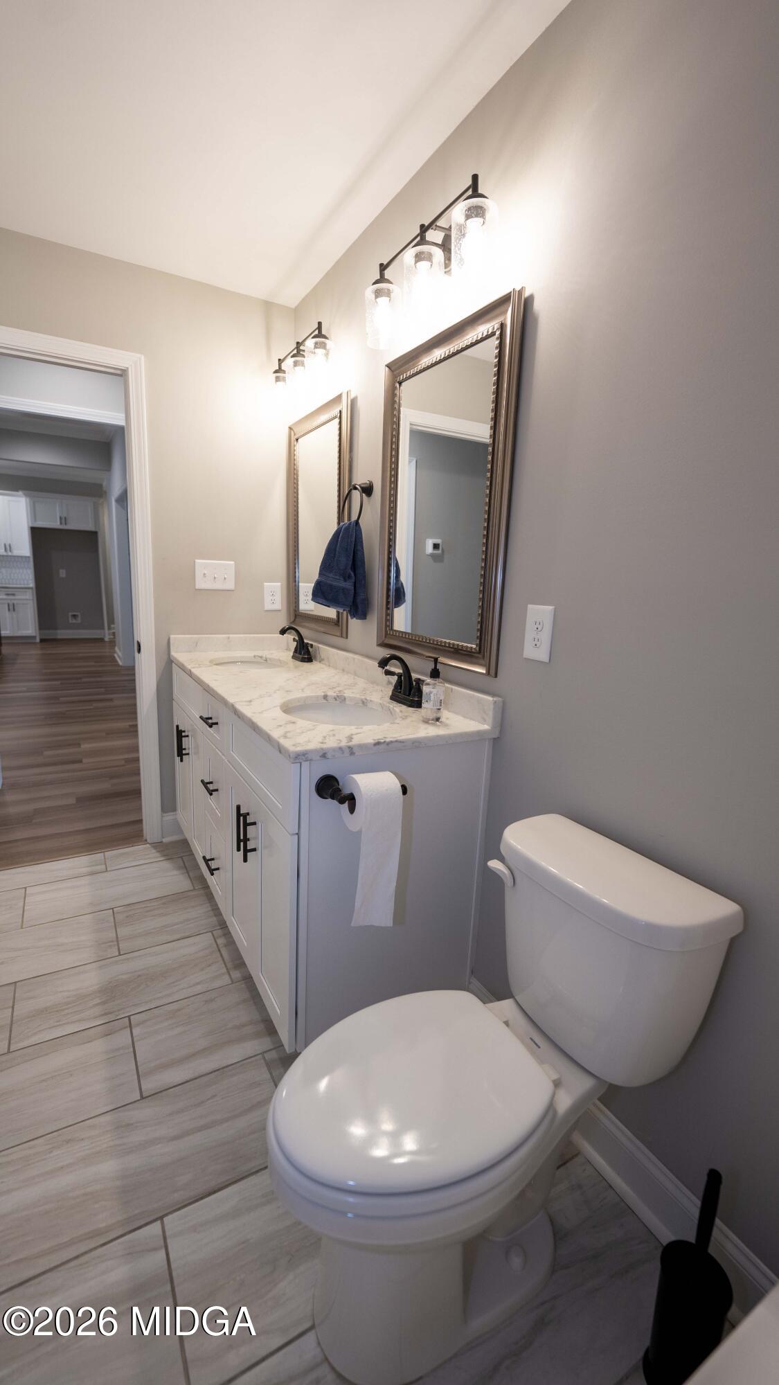 219 Otters Ridge Drive Kathleen, GA 31047 - Photo 34 of 44 a bathroom with a toilet sink and mirror